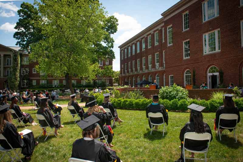graduates sitting at hooding ceremonies