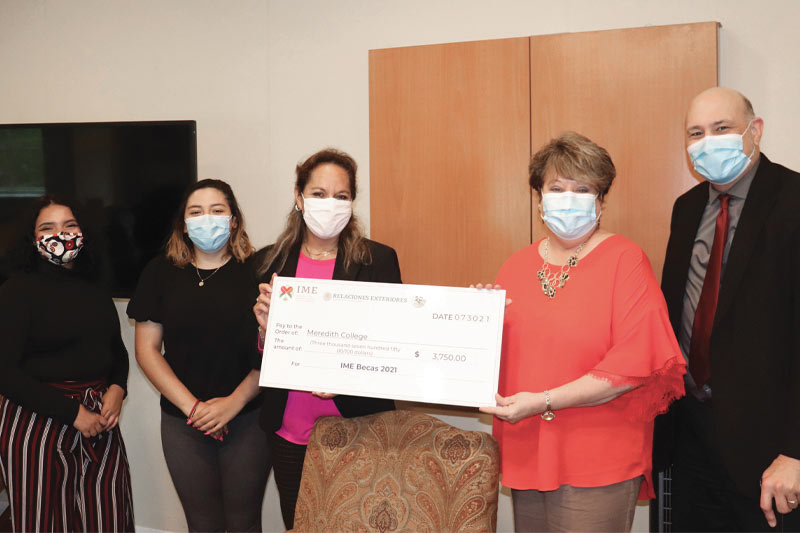 President Jo Allen poses with four others around a large check donation.