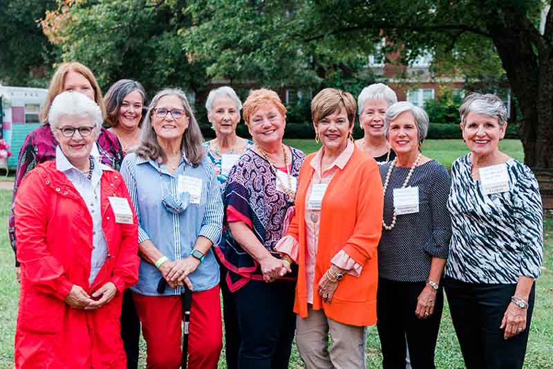 A group of alumnae smiling for a photo.