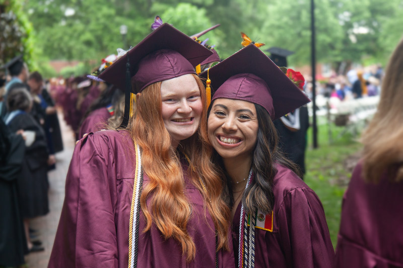 Two graduates smiling.