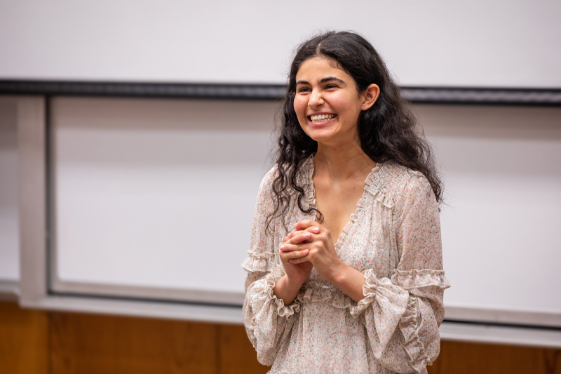 A student smiles after presenting.