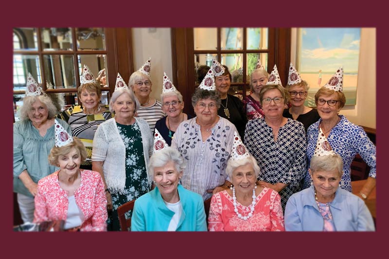 Alumnae of the class of 1964 smile in a group photo.