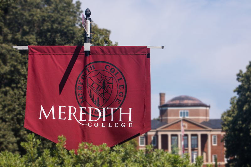 A meredith college banner outside of Johnson Hall.