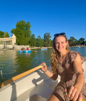 A student on a paddle boat while on a trip.