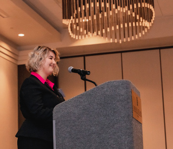 A person delivers a speech at a podium.