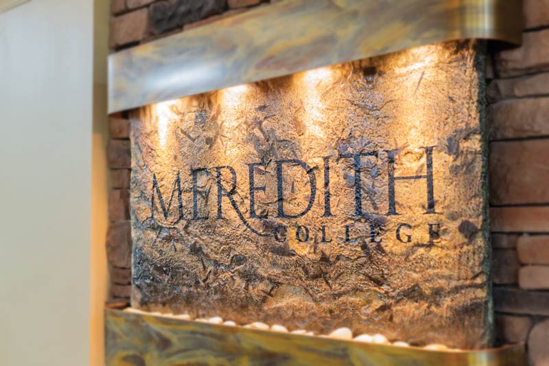 The stone water feature with "Meredith College" engraved on it in  the belk dining hall building.